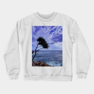 A palm tree on rock plateau with a rock island in the sea Crewneck Sweatshirt